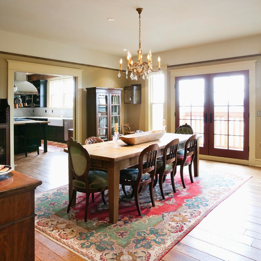 A big oriental rug brings a fresh energy into a countryside dining room