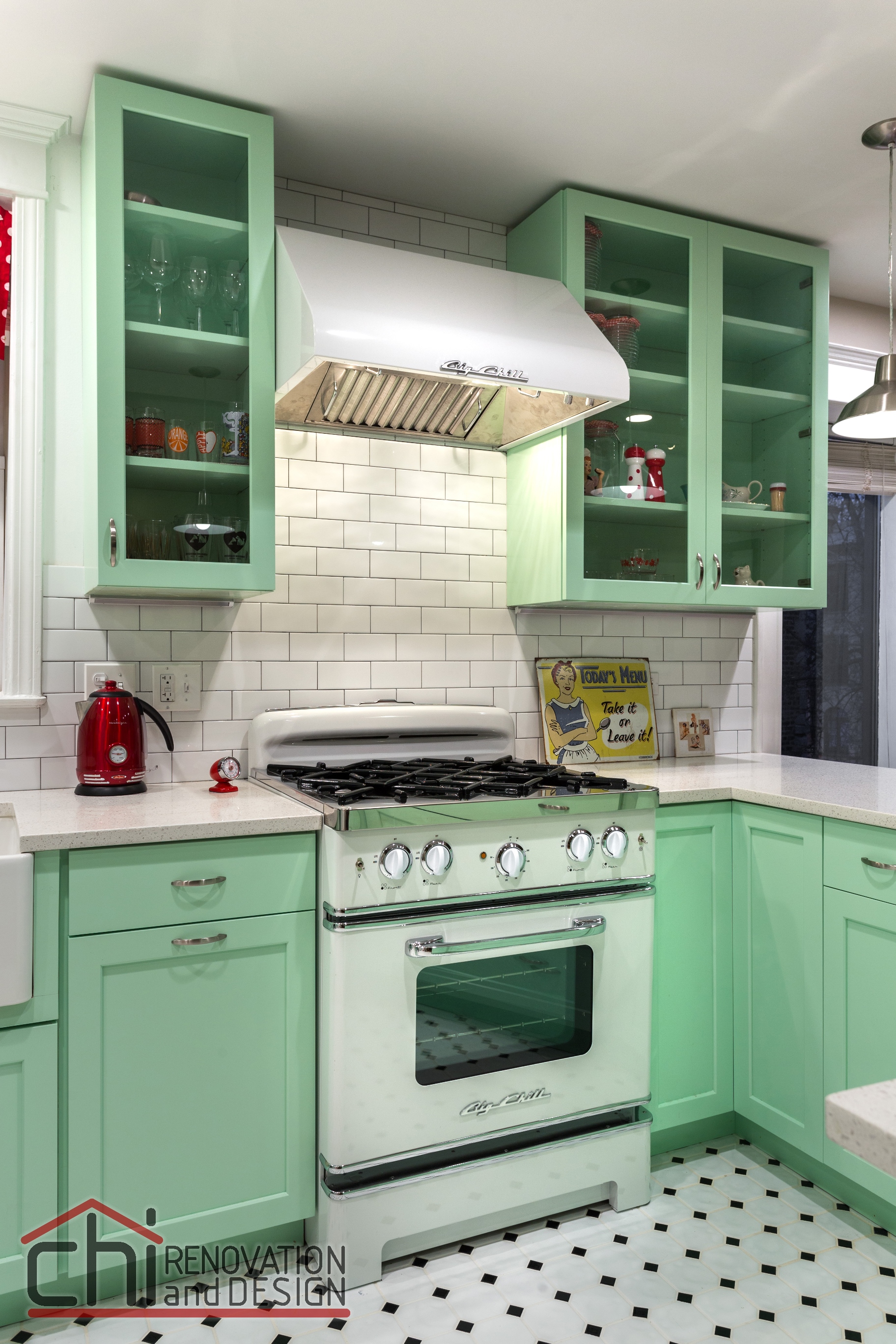 A bold mint green kitchen in combination with a retro stove