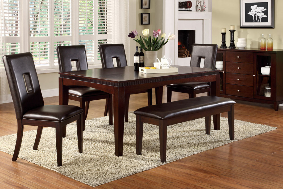 A dark dining room with a light rug