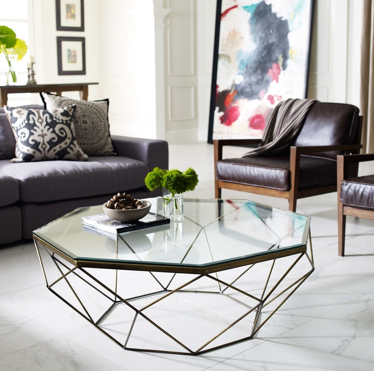 A geometric glass coffee table adds dynamic and transparency to the room