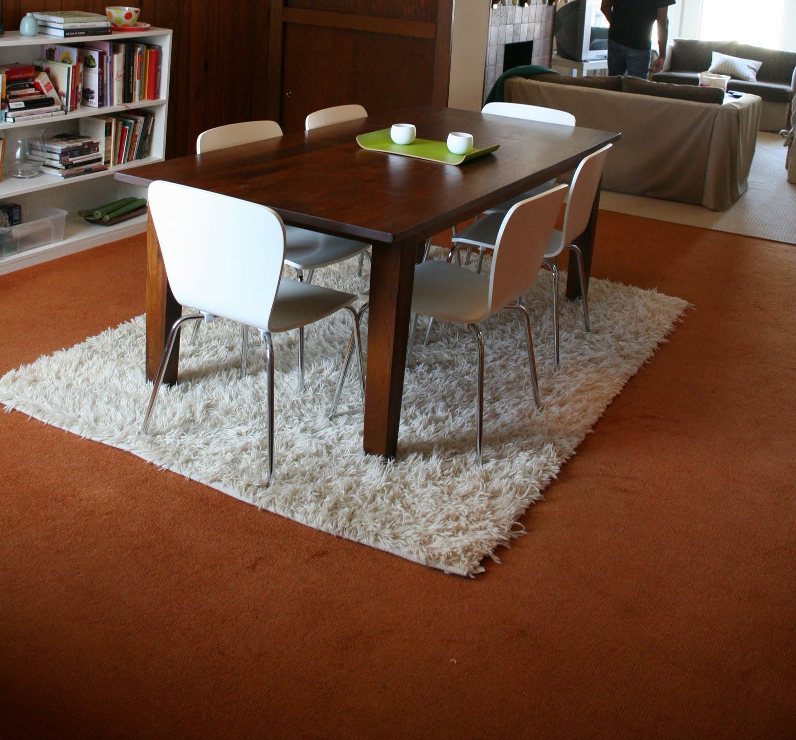 A white ruffled rug tips the scale in this dining room