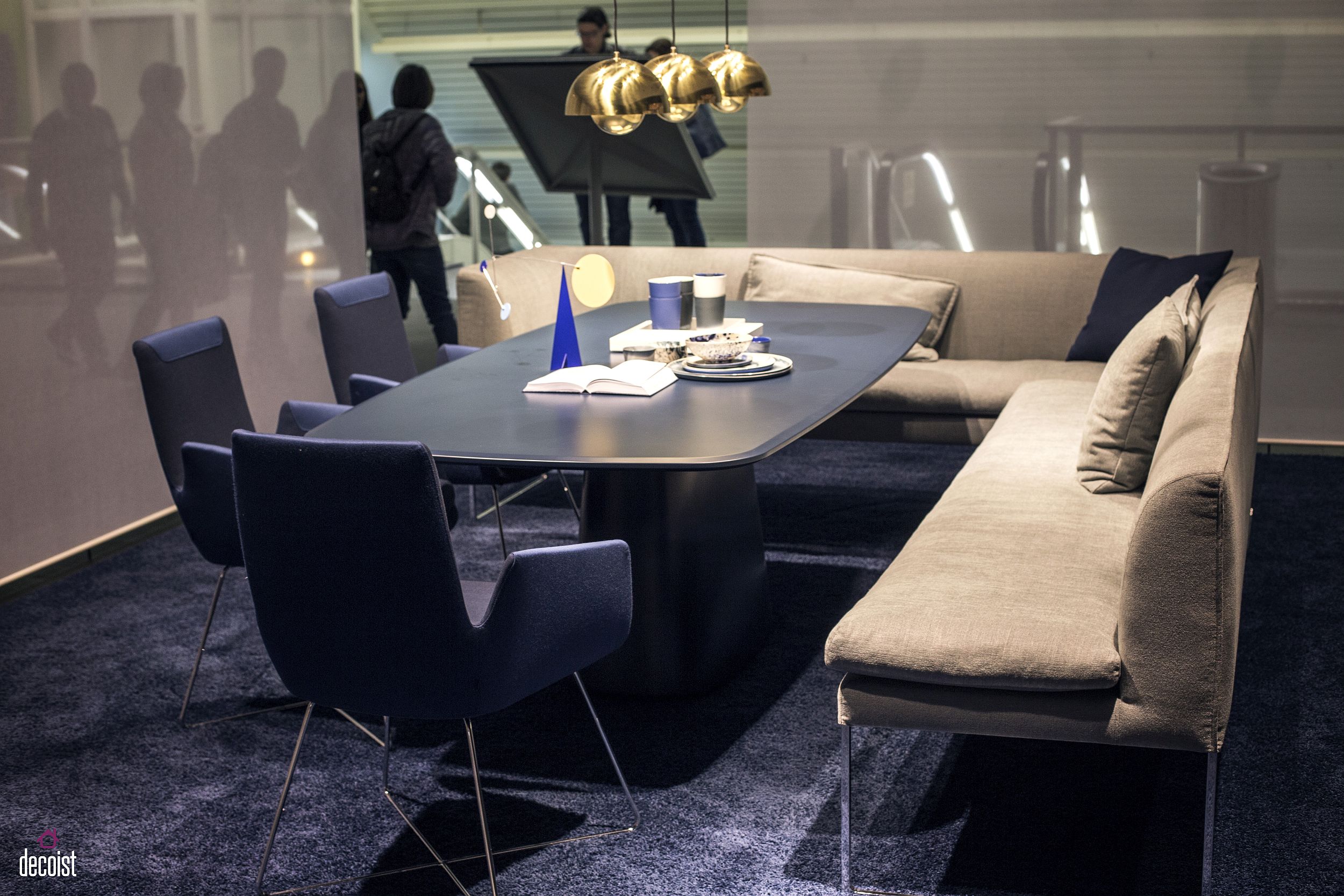 Booth style seating coupled with blue chairs and a dashing table in the contemporary dining room