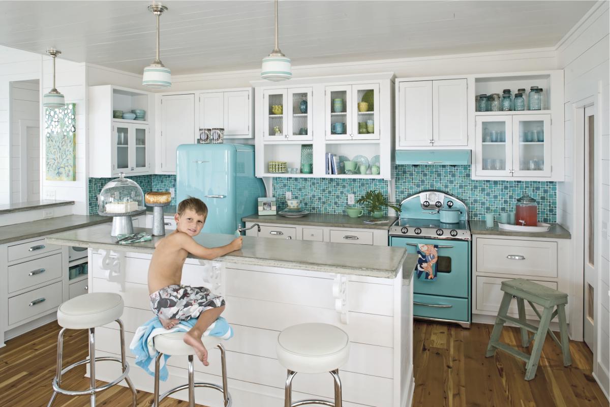 Bright kitchen with a retro fridge, stove and a matching backdrop