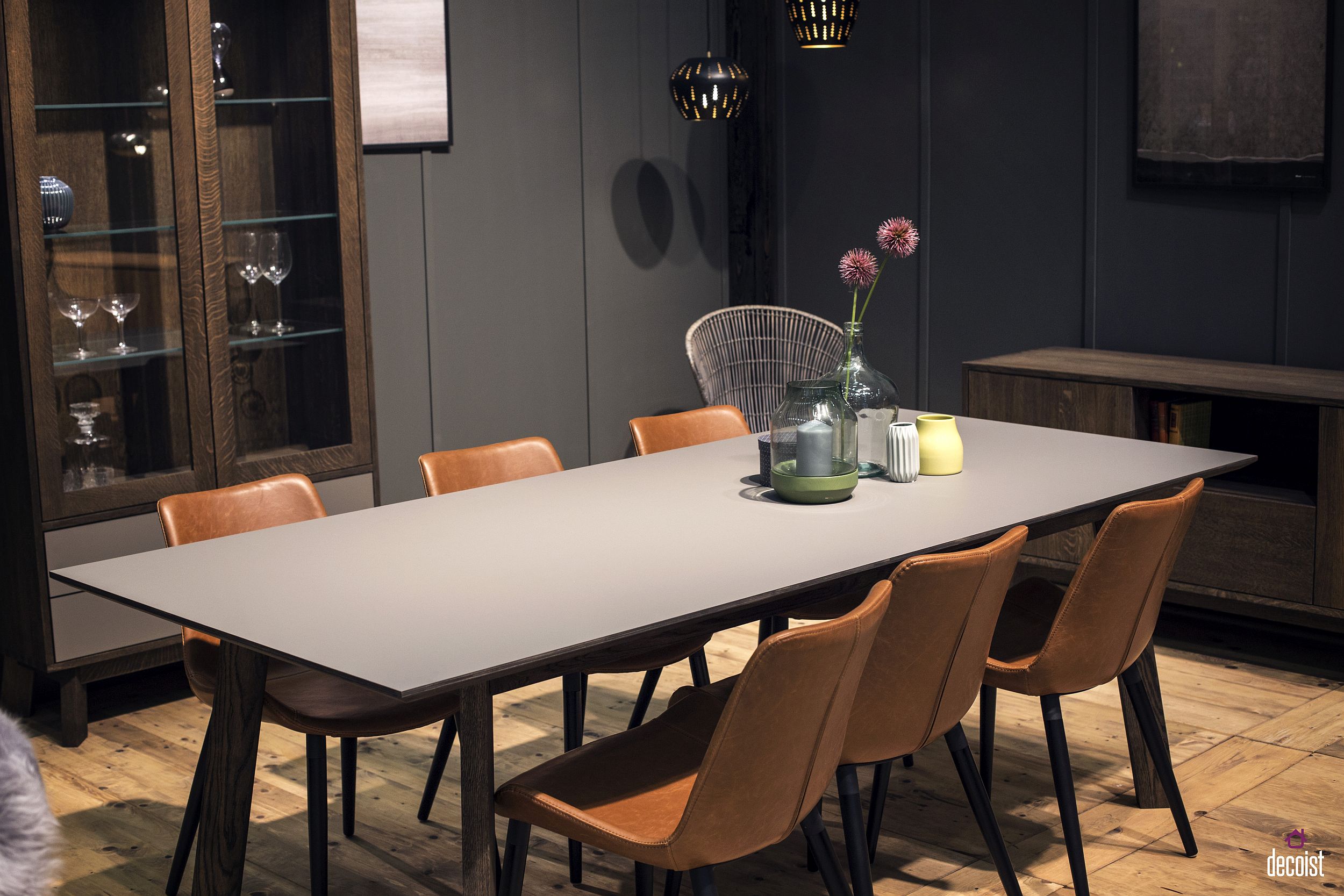 Brown-leather-chairs-and-a-gray-backdrop-give-the-dining-room-a-sophisticated-masculine-look