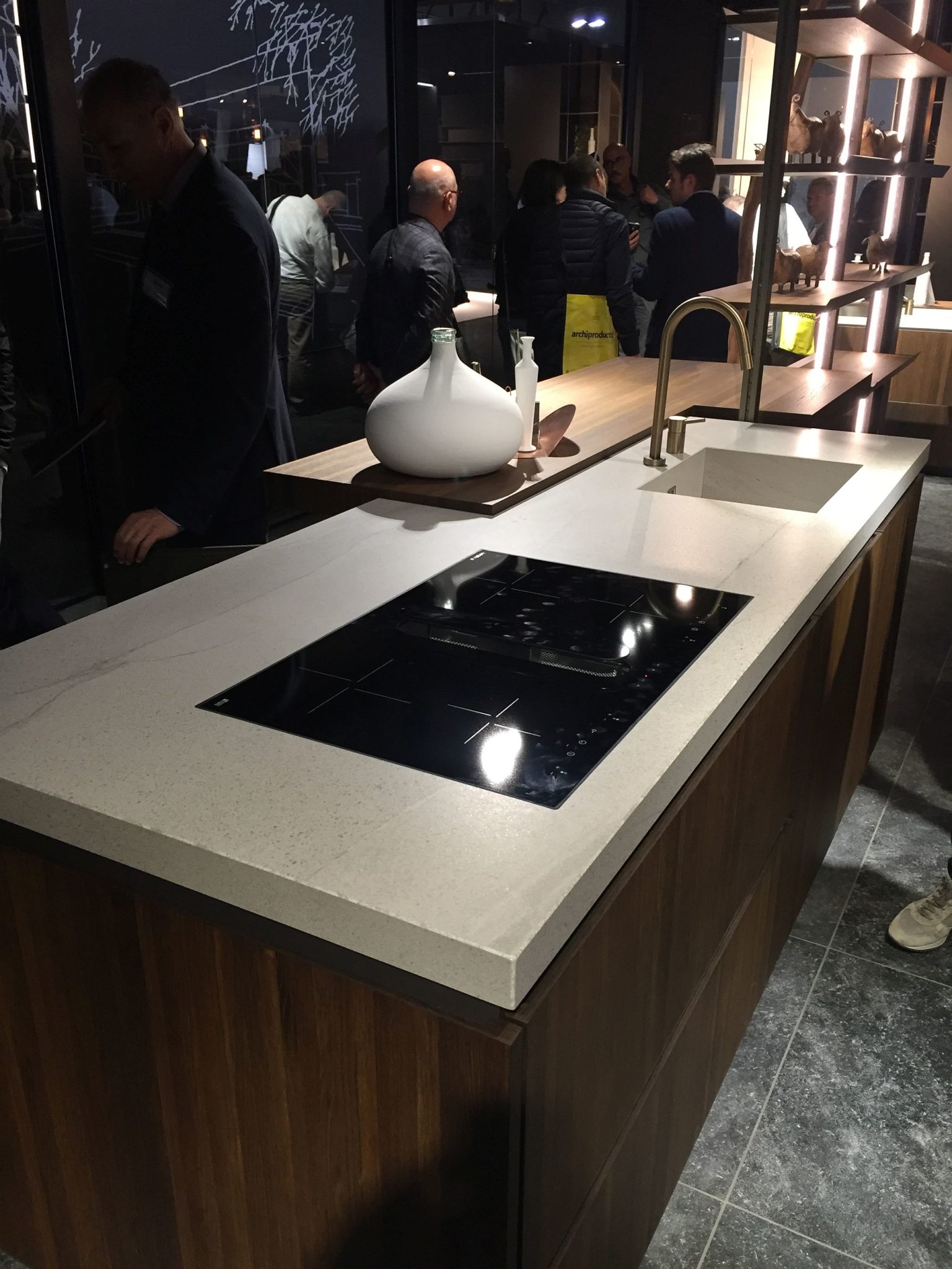 Clean marble worktop combines with wooden cabinets and open shelving