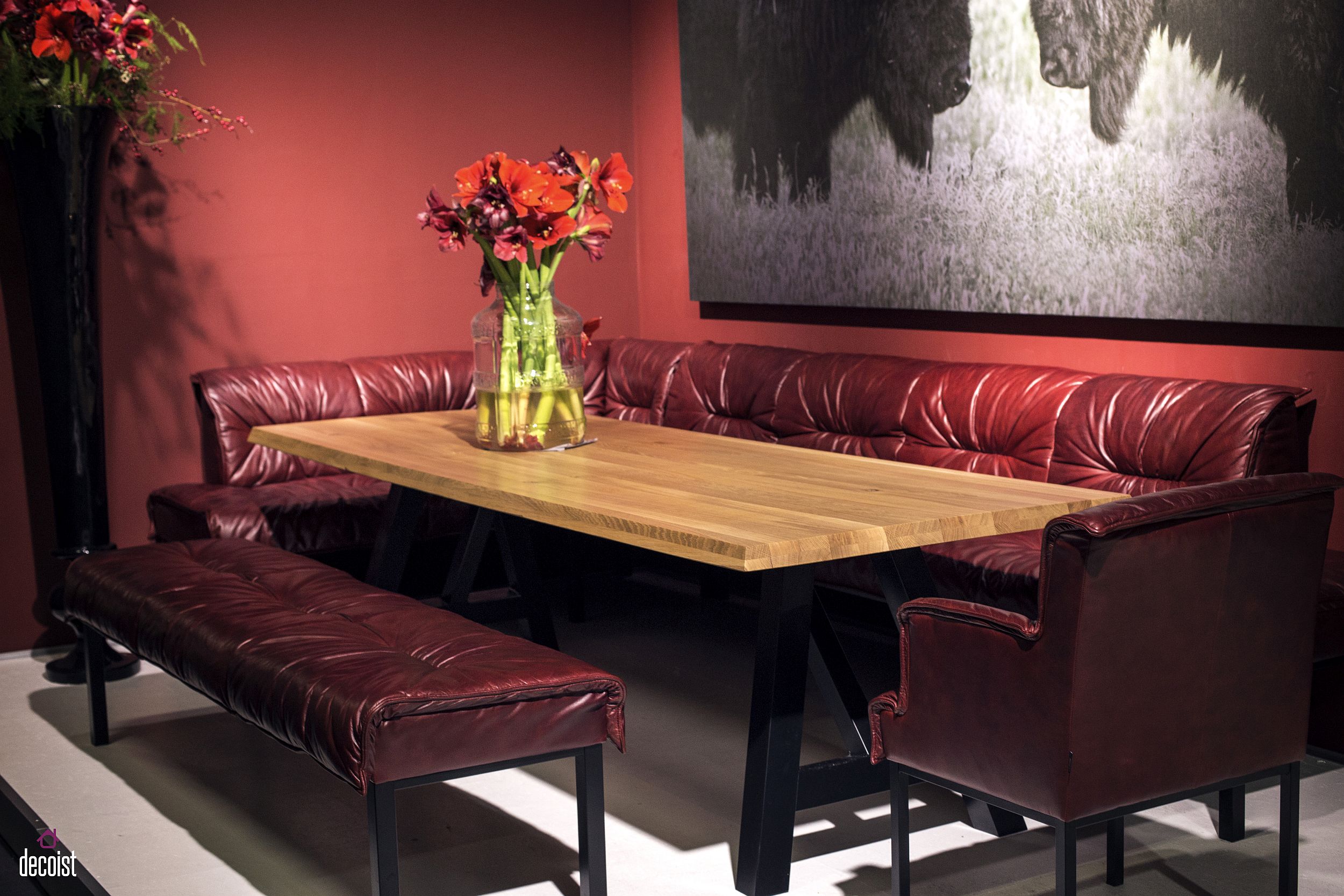 Comfy red banquette style seating along with a bold backdrop creates a stunning dining area