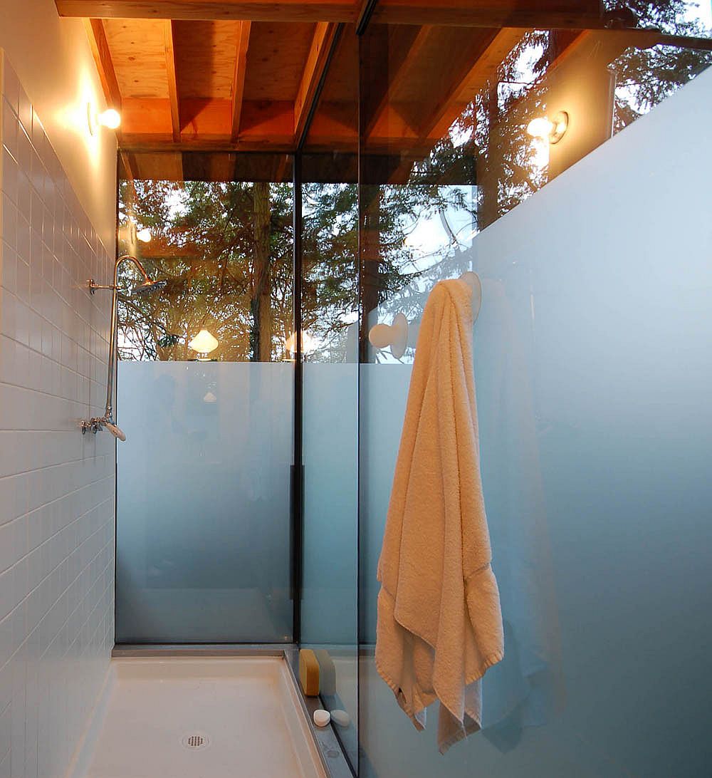 Contemporary bathroom at the cabin with wooden ceiling and glass windows