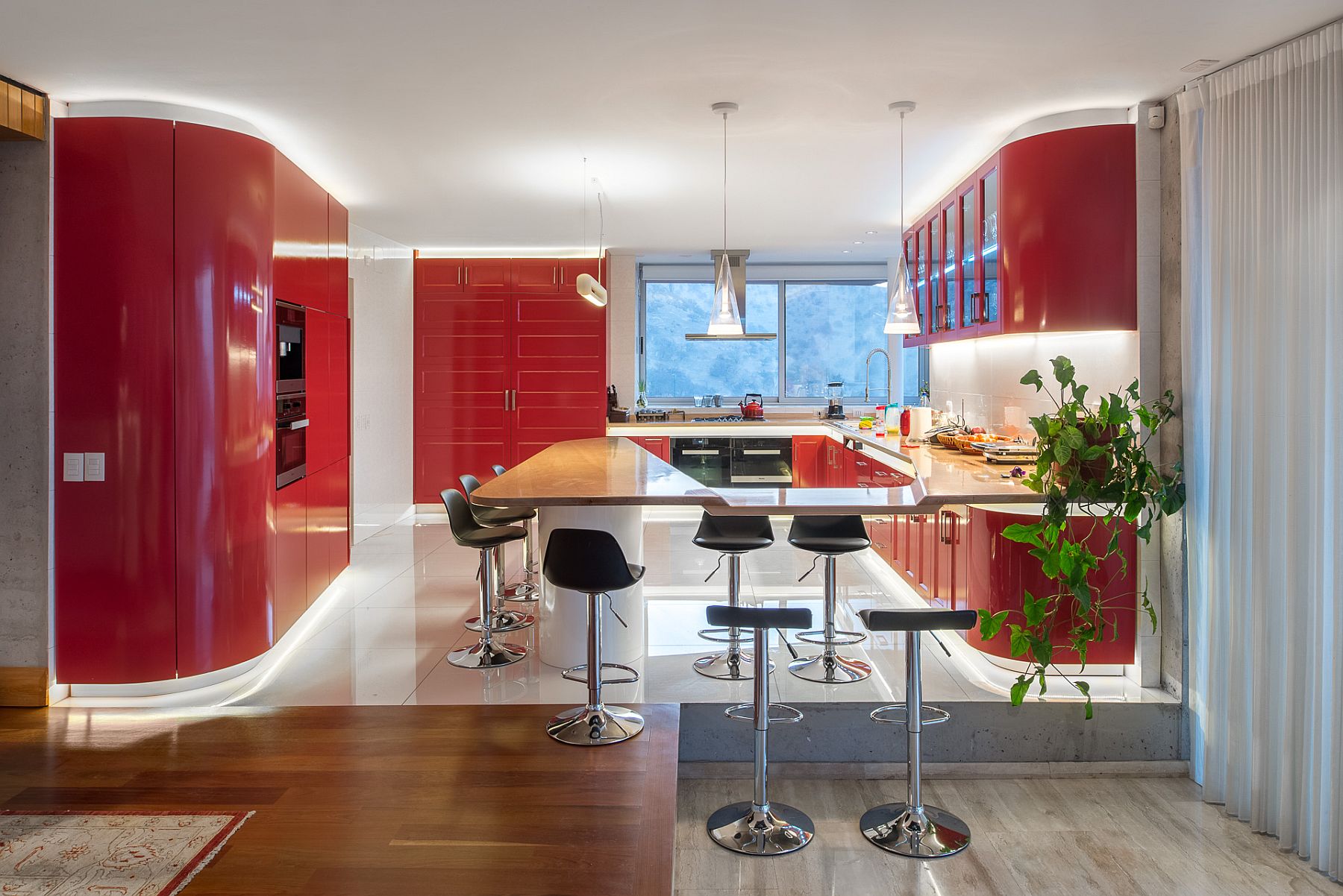 Contemporary kitchen in red and white with dazzling LED lighting