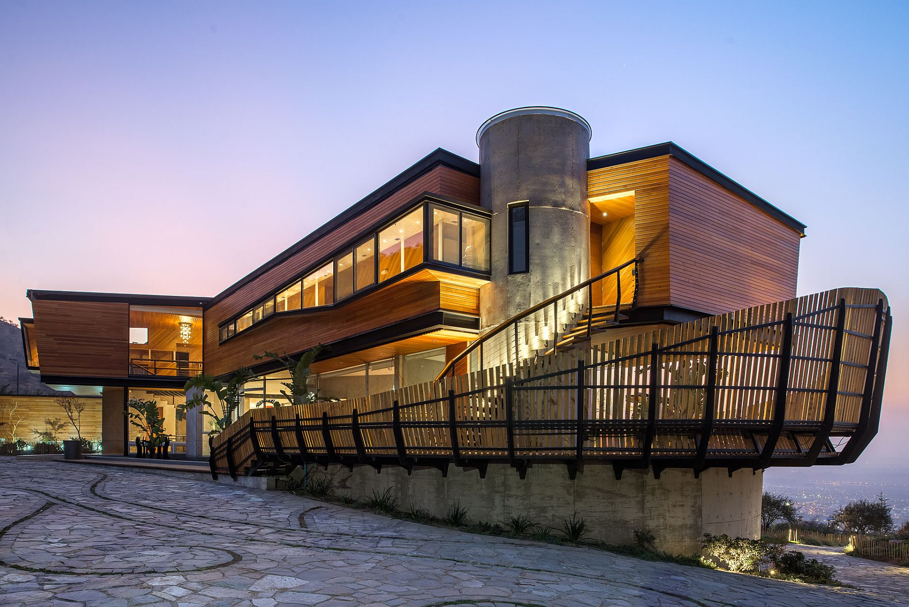 Custom steel and timber fence wraps around the home to give the lower level ample privacy Sculptural Design at Its Spectacular Best: Luxurious Mountain Home in Chile