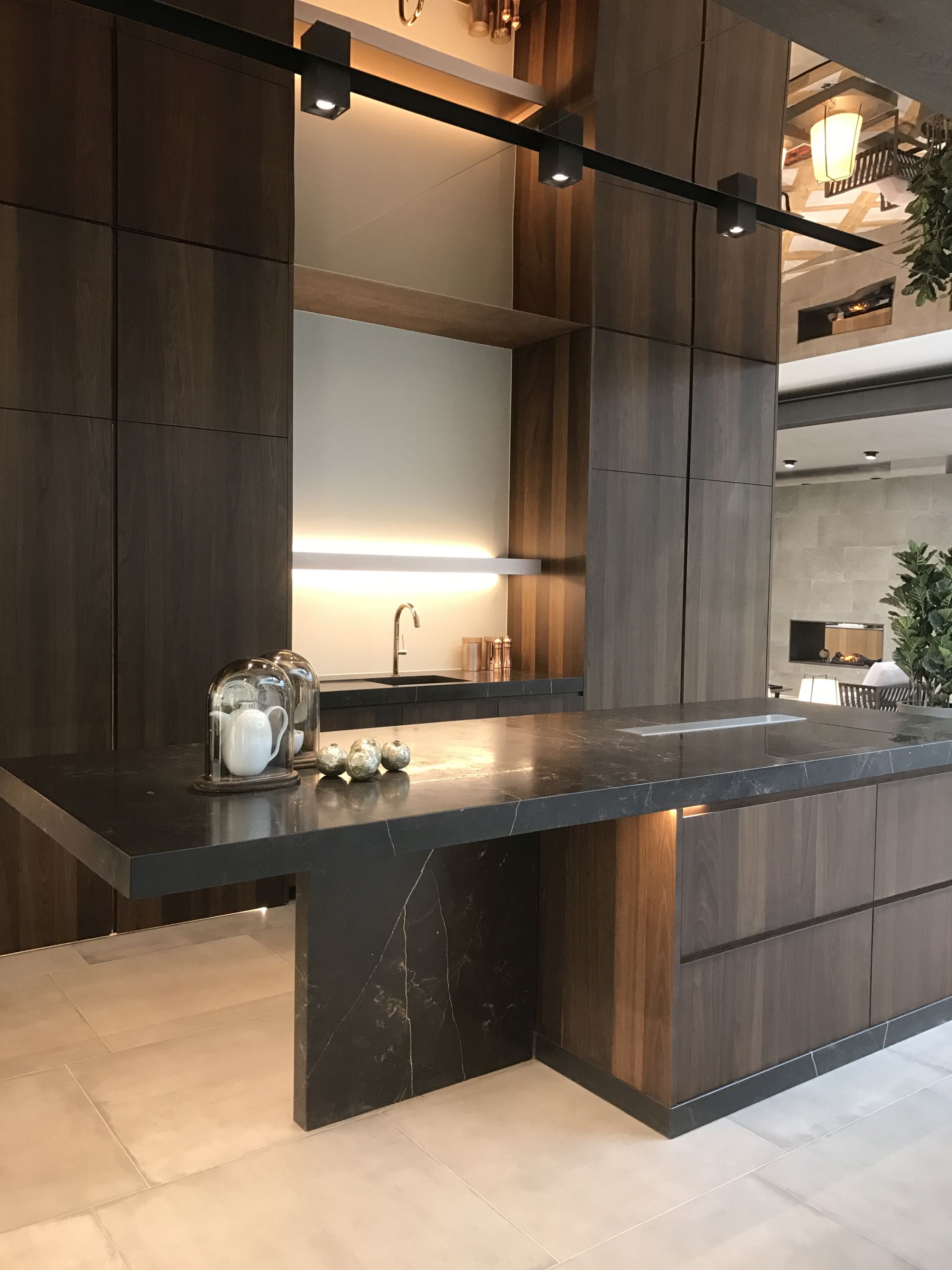 Dark wood inspired ceramics for kitchen cabinets by Porcelanosa