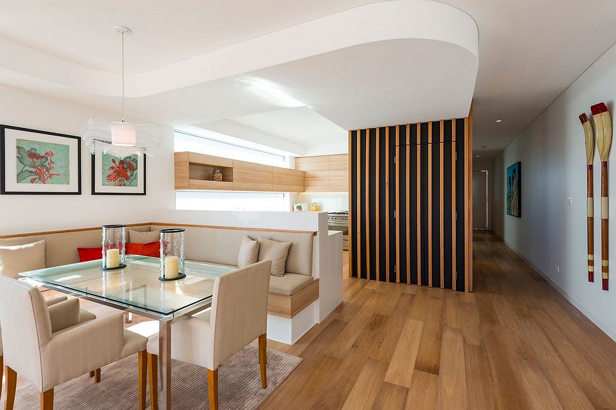 Dining booth in white with pops of red inside the Sydney home