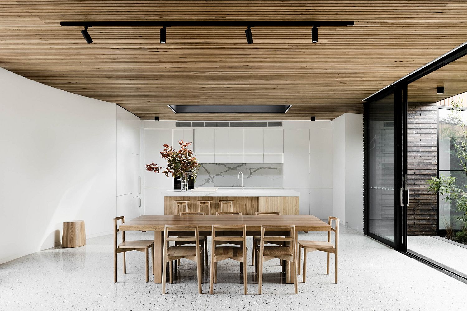 Dining room and kitchen in white with wooden ceiling