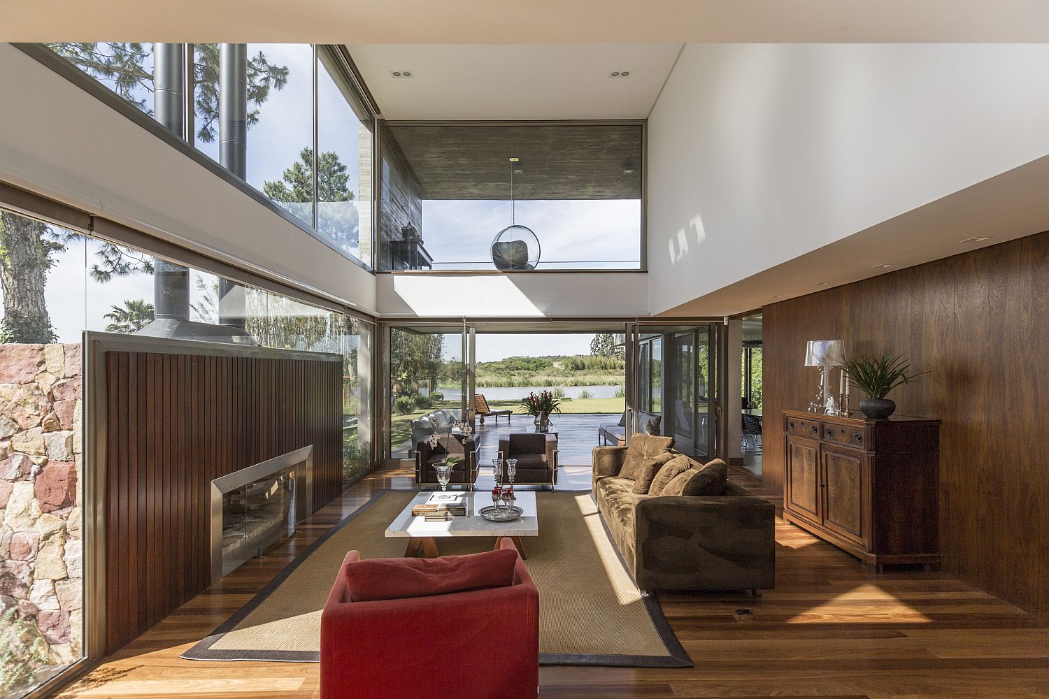 Double height living room of the spacious Brazilian home with river views