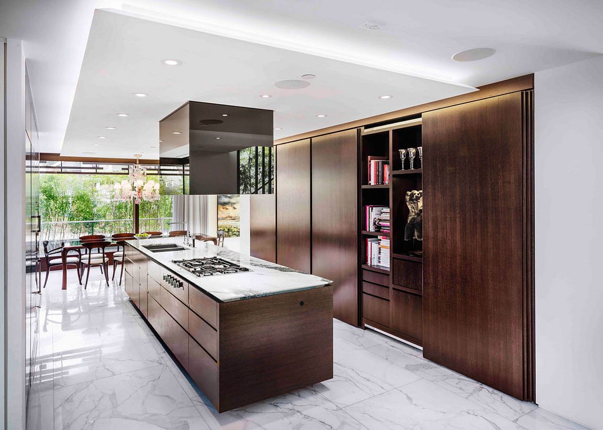 Exquisite contemporary kitchen in white with central island and shelves in dark wood
