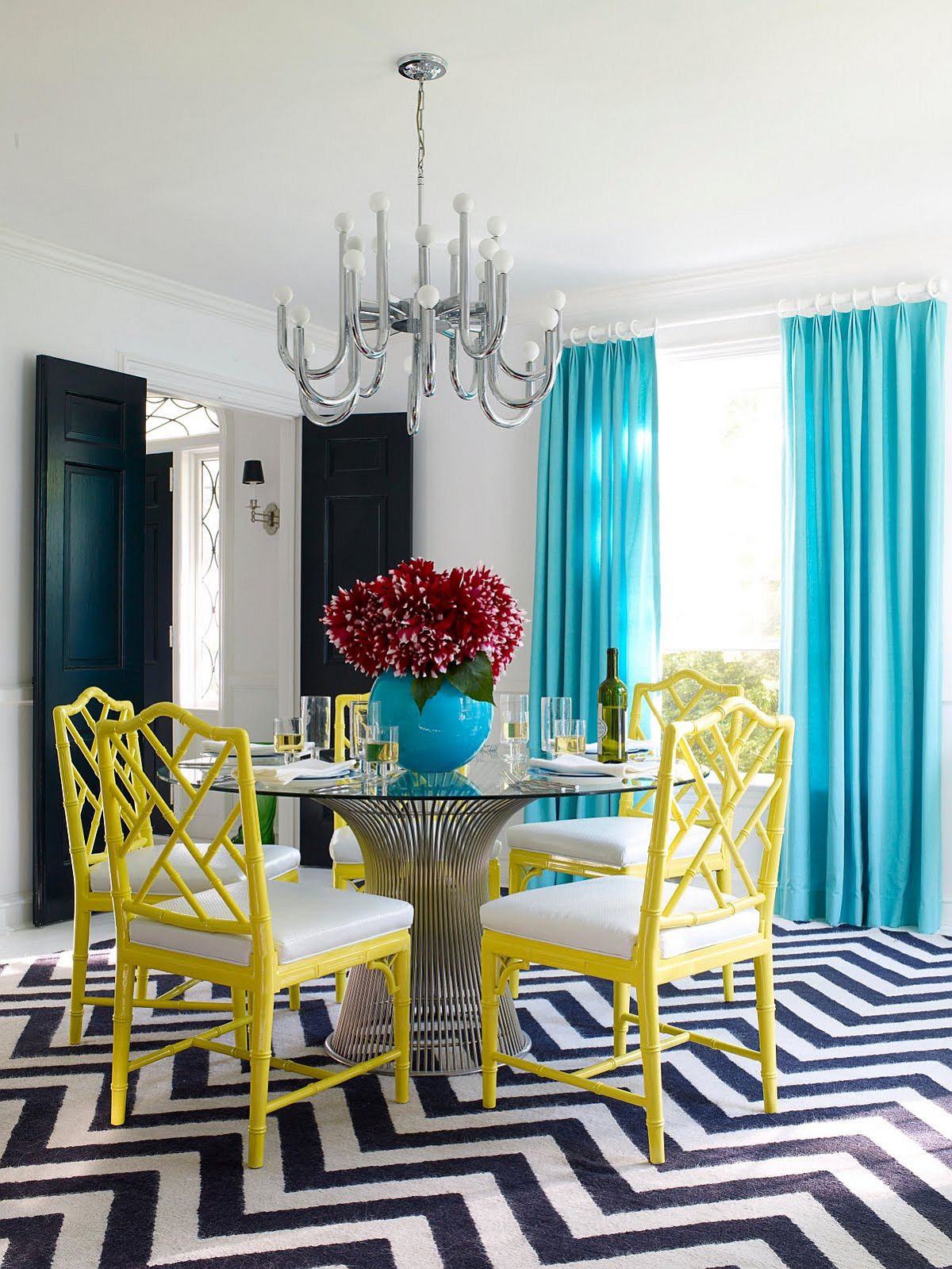 white dining table with multi coloured chairs