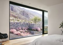 Floor-to-ceiling-window-connects-the-bedroom-with-the-rugged-mountain-landscape-217x155