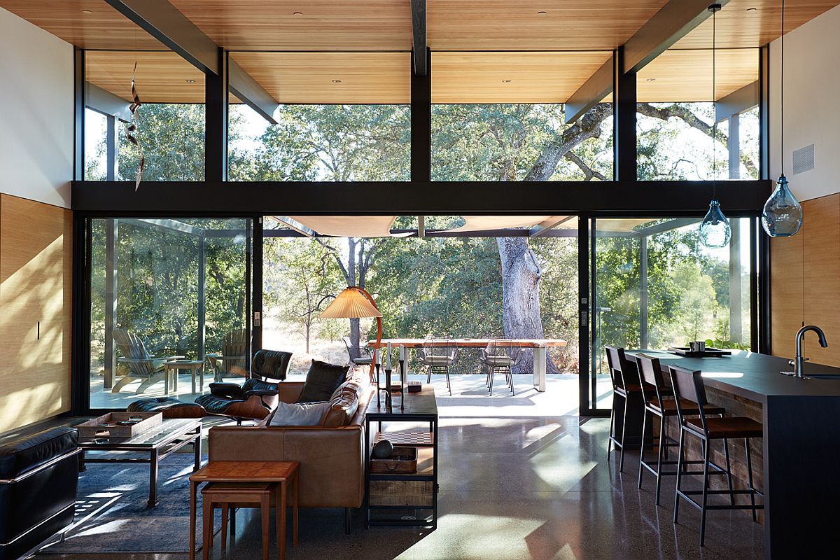 Glass walls and doors connect the living area with the landscape outside