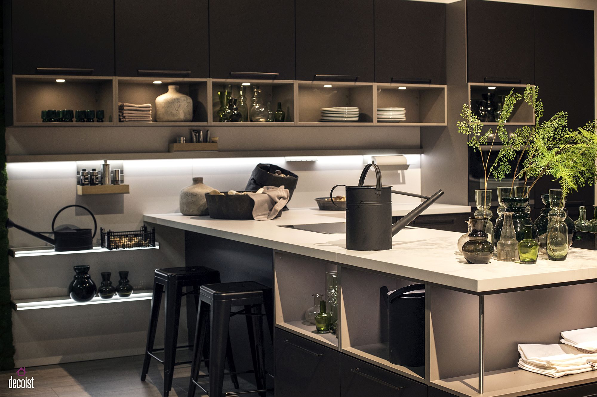 Gray kitchen island with white countertop and a dashing dark backdrop