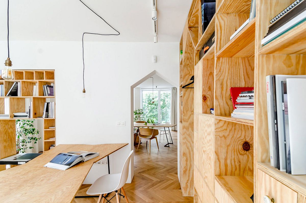 Innovative apartment studio with wooden desk and chevron pattern flooring