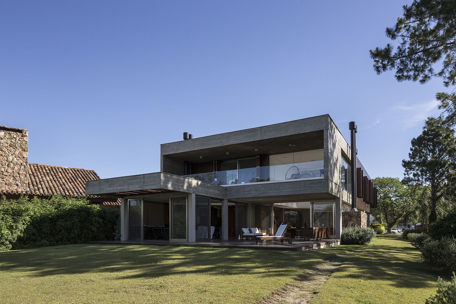 Large garden and wooden deck with ample shade combine to create a relaxing outdoor social zone