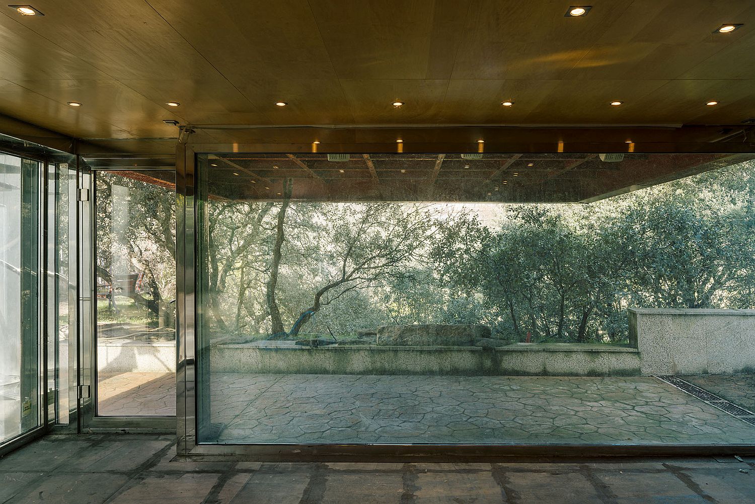 Large glass windows and walls bring the outdoors inside with ease