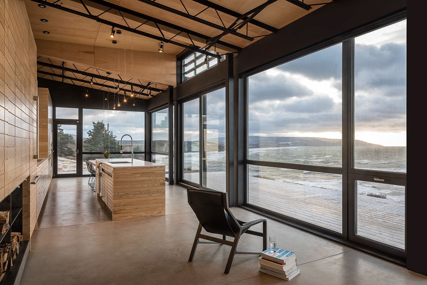 Large-windows-and-glass-doors-open-up-the-kitchen-towards-the-stunning-coastline-and-the-ocean-beyond