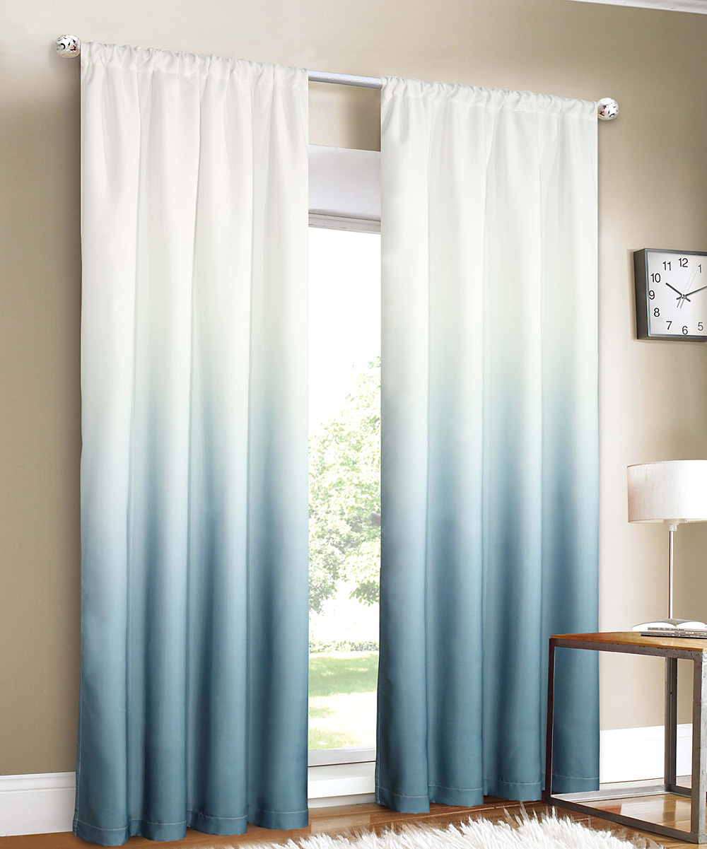 Light blue ombre curtains that stand out in a brightly lit room