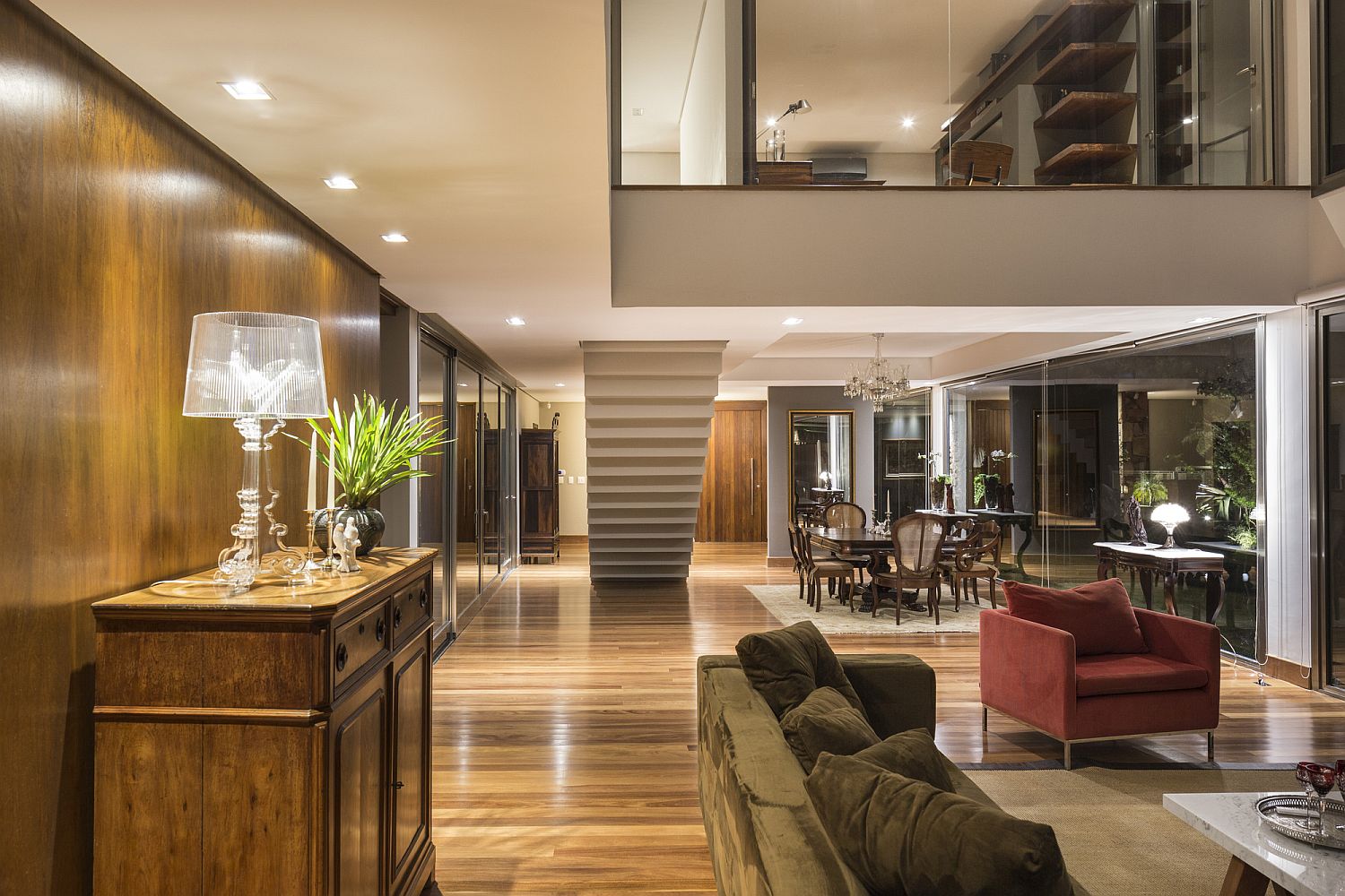 Mezzanine level with glass wall overlooks the lower living area