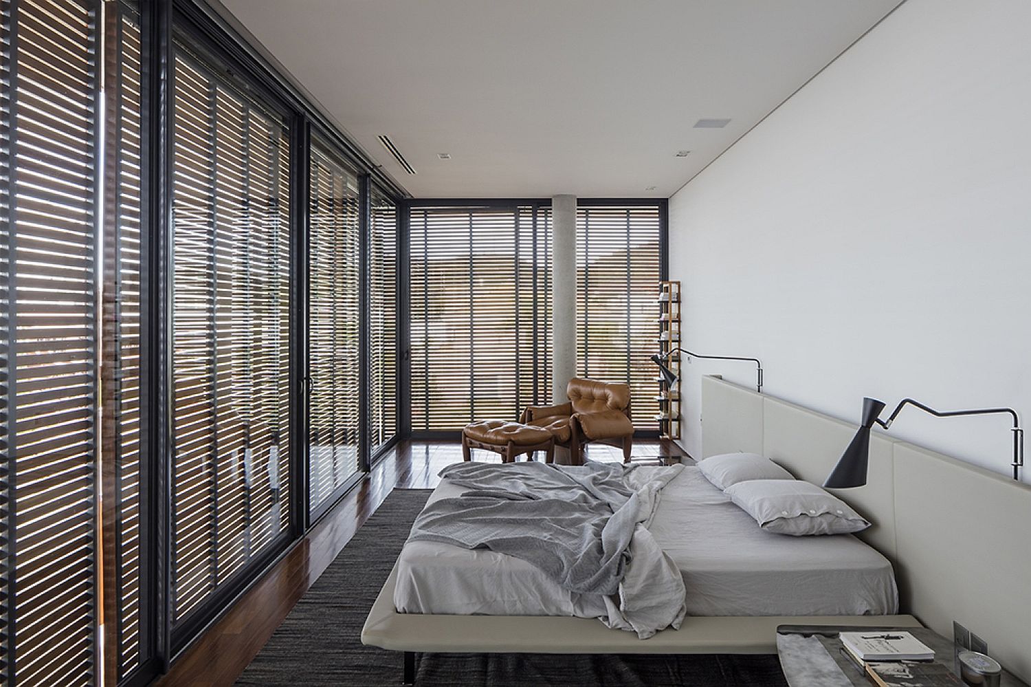 Modern bedroom in white with glass walls and wooden slats