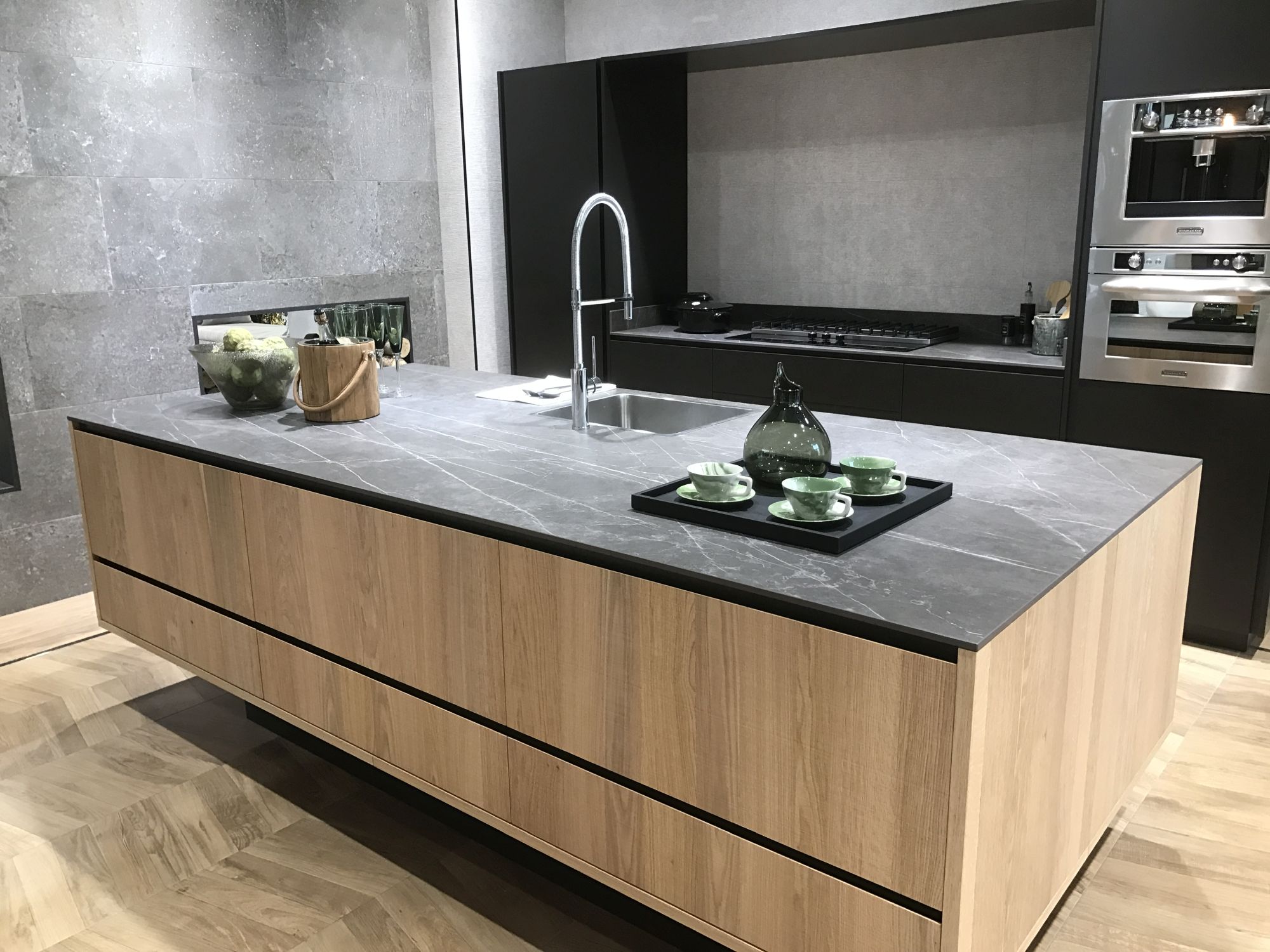 Modern kitchen with parquet inspired ceramic floor tiles by Porcelanosa