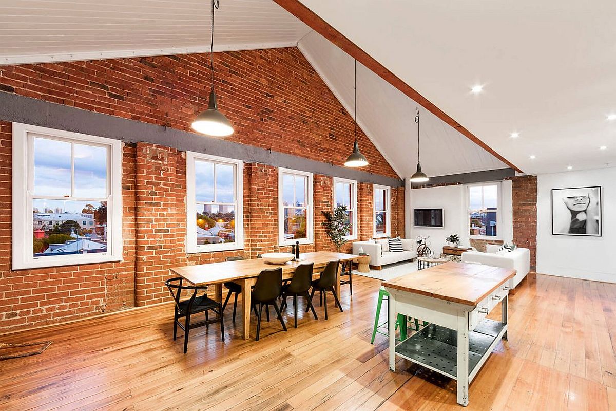 Old brick along with beam-and-truss ceiling give the apartment industrial charm