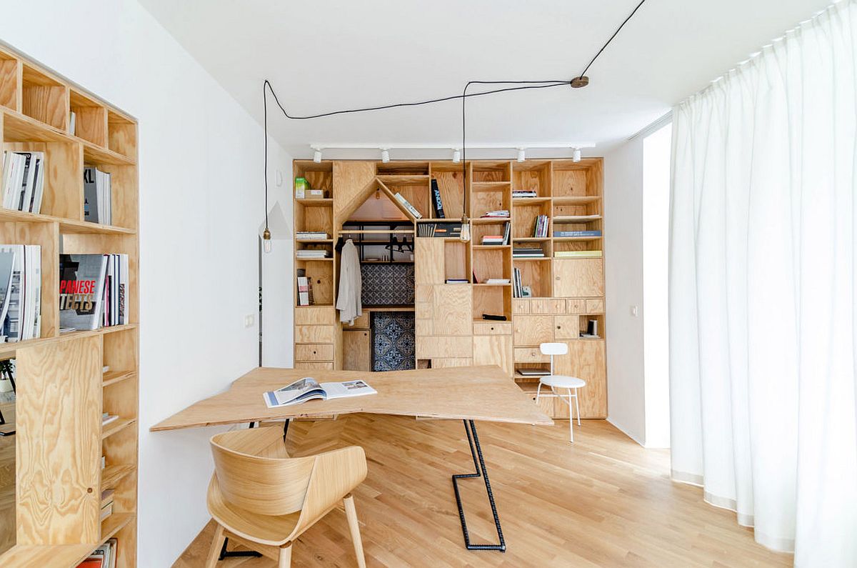 Plywood partitions and wooden decor transform apartment into unique workspace