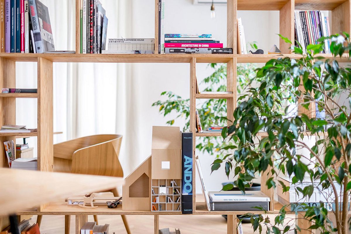 Smart mix of shelves and cupboards creates ingenious wooden partitions that replace walls