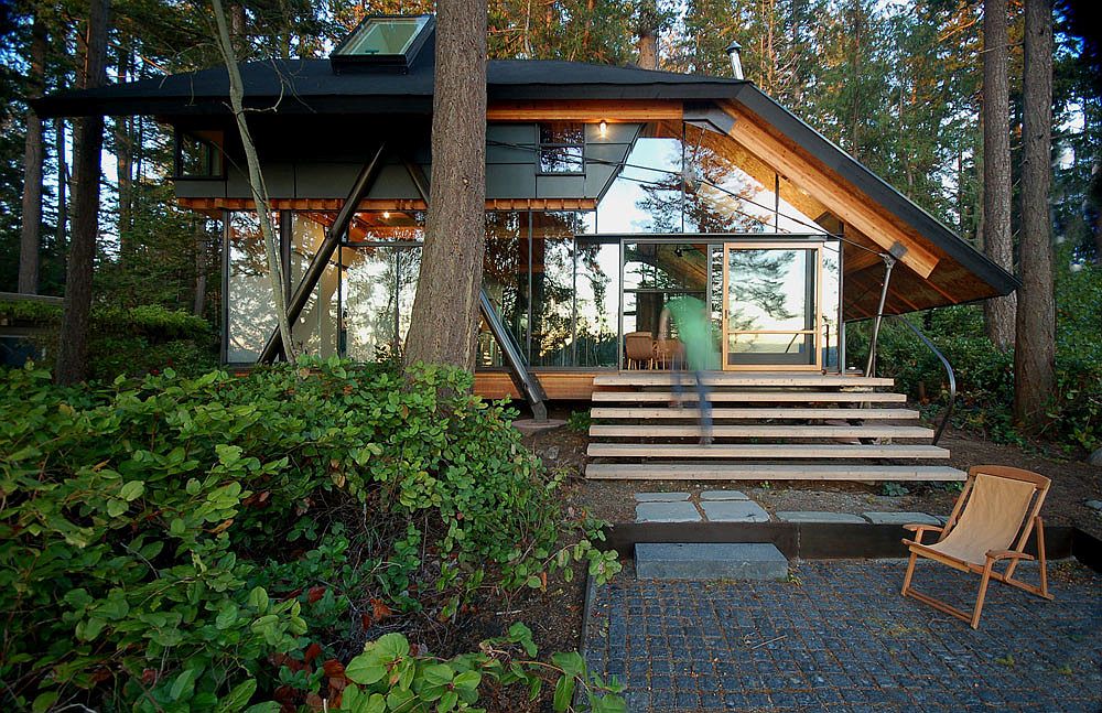 Sneeoosh Cabin set in a lush green landscape surrounded by fir and cedar trees