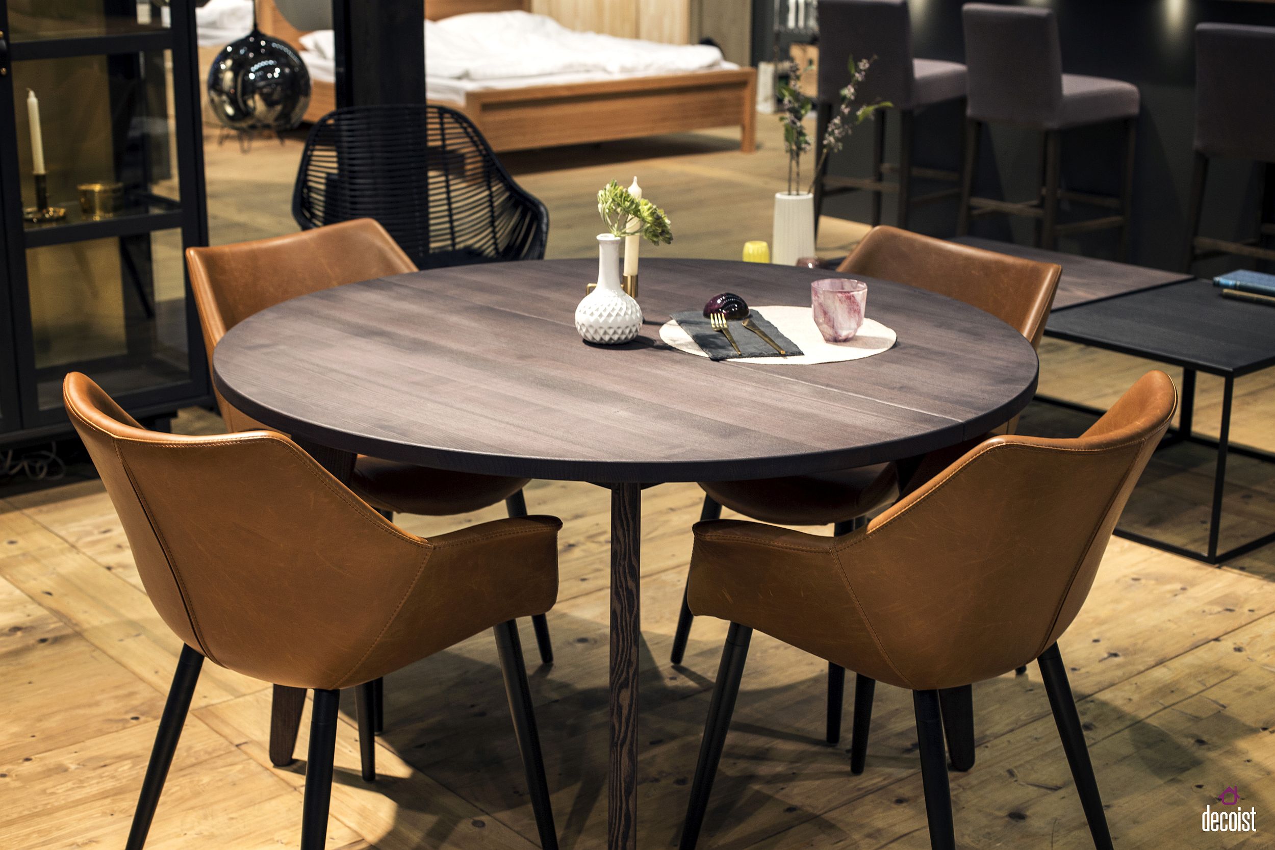 Space-savvy wooden round dining table with a sleek base