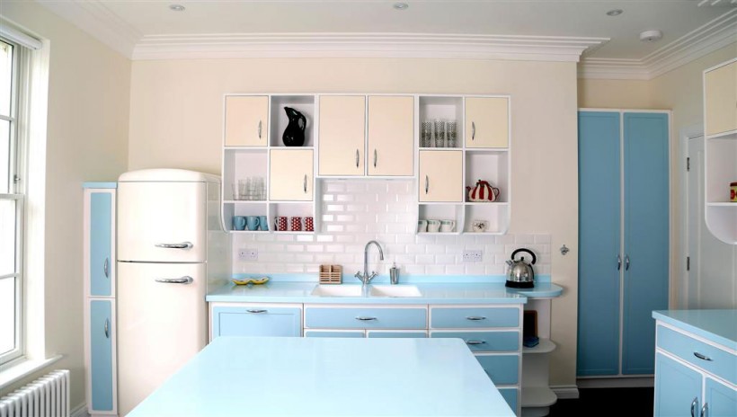 Spacious kitchen easily pulls off the retro look with an abundance of blue