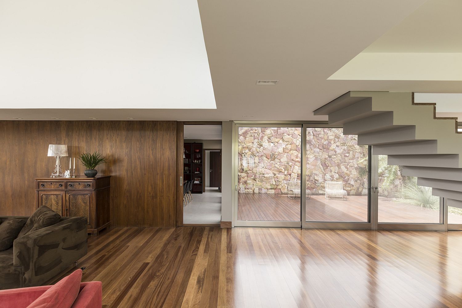 Stone wall outside becomes an integral part of the interior at Casa no Arroio Pelotas