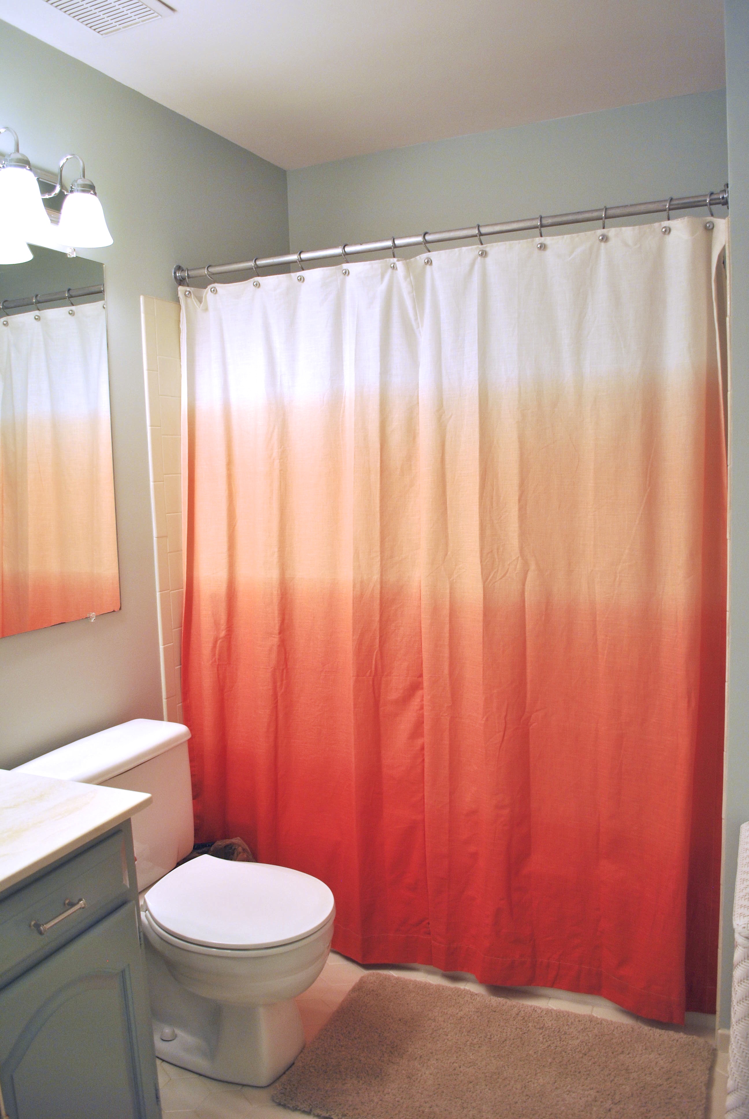 The red ombre shower curtains make up a truly spirited bathroom