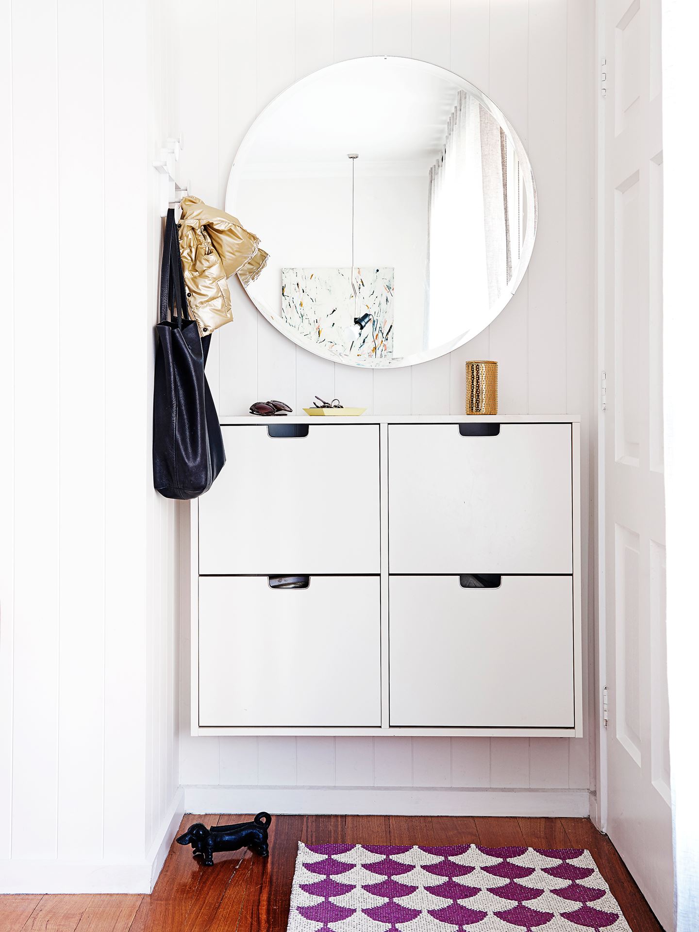 Tight-entryway-with-a-big-mirror-and-wall-mounted-cupboard