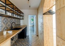 Tiles-bring-color-and-pattern-to-the-studio-kitchen-with-a-coat-hanger-217x155