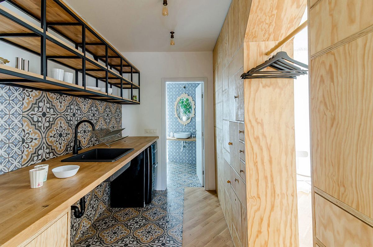 Tiles bring color and pattern to the studio kitchen with a coat hanger