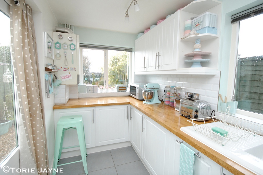 Tiny kitchen with many pastel elements