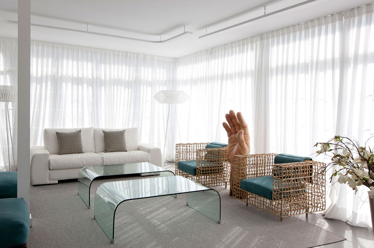 Two identical glass tables retain the breeziness of the room