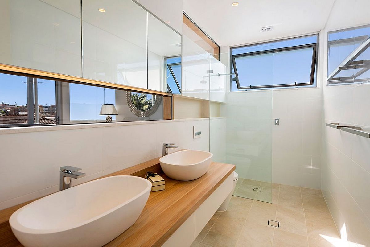 White modern bathroom with floating vanity, wooden countertop and twin sinks