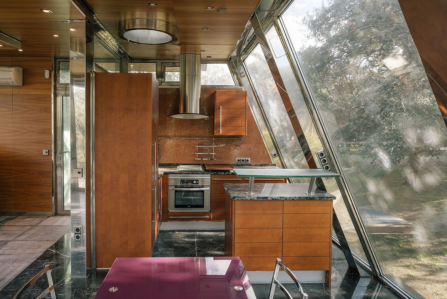 Wooden kitchen with glass walls at the Hidden Pavilion