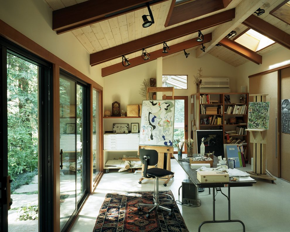 Art studio with wooden ceiling beams and skylight.