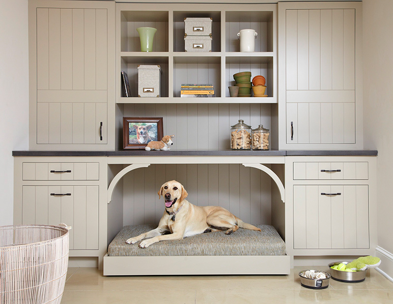 A big storage cabinet with a built-in dog bed