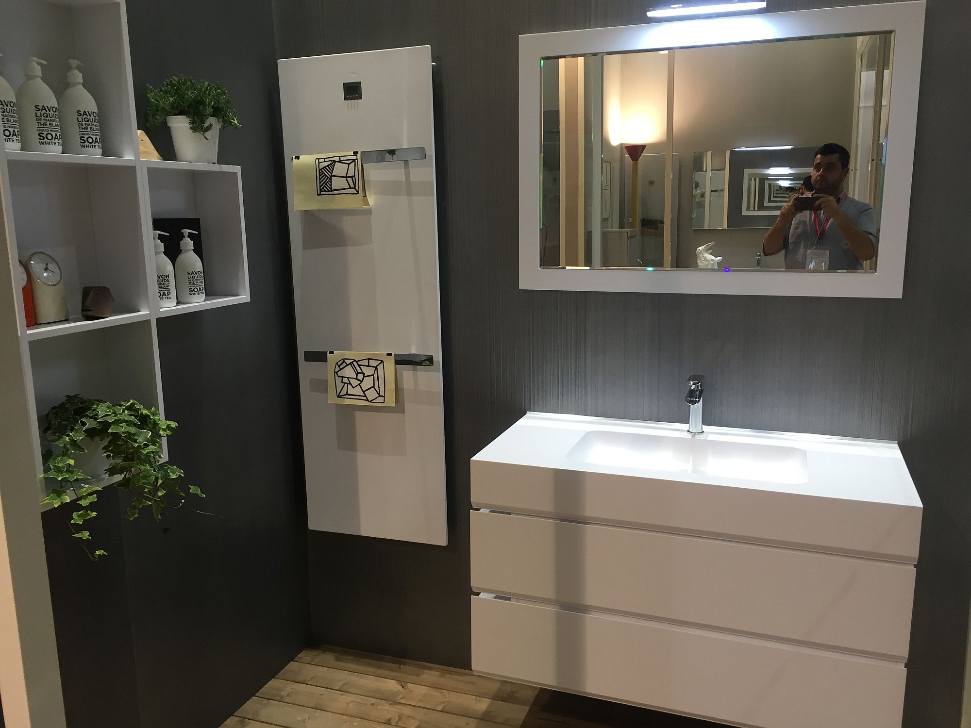 A simple towel hanger next to the sink with additional open shelving