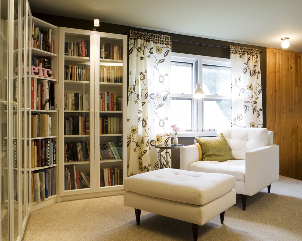 A spacious nook with a big reading chair and ottoman