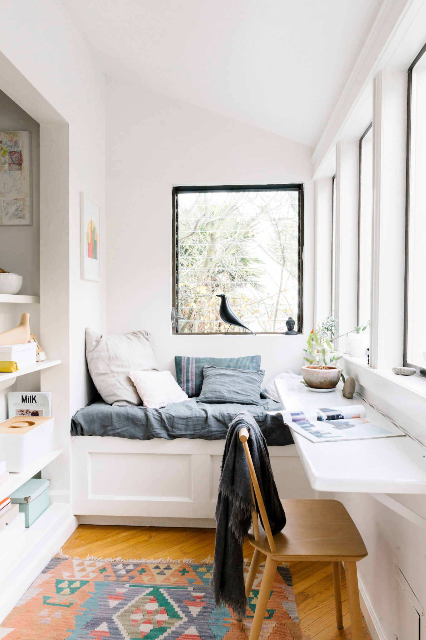 A well-lit reading nook surrounded by windows